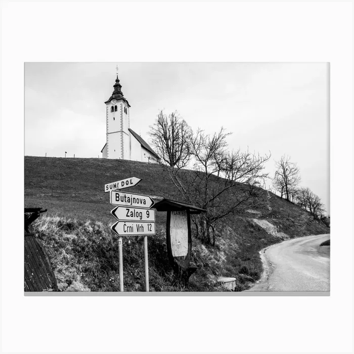 Roadsigns Near Slovenian Hilltop Church Canvas Print by Mark Koghee